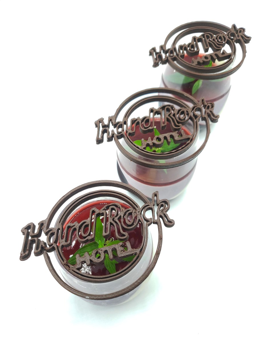 Rack of grilled lamb chops hanging above candles and cheese platter.